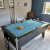The Blackball slate bed pool table in a room.