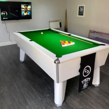 The Blackball slate bed pool table in a room.