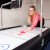 A girl playing Sure Shot Super Pro Air Hockey.