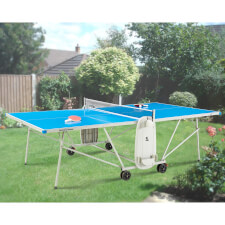 The Quickfold Outdoor tennis table in a garden.