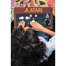 Girl playing Arcade1UP Atari Couchcade.