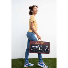 Girl holding the Arcade1UP Atari Couchcade.