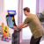 Man playing Arcade1up Bandai Namco Pac-Mania legacy arcade machine.