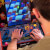 Man playing Arcade1up Bandai Namco Pac-Mania legacy arcade machine.