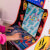 People playing Arcade1up Bandai Namco Pac-Mania legacy arcade machine.