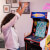 People playing Arcade1up Bandai Namco Pac-Mania legacy arcade machine.