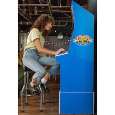 Girl playing Arcade1Up Street Fighter II Blue Machine.
