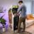 Man playing Arcade1up Atari legacy Centipede arcade machine.