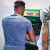 Man playing Arcade1up Atari legacy Centipede arcade machine.