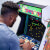 Man playing Arcade1up Atari legacy Centipede arcade machine.