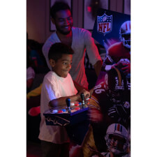 The NFL Blitz arcade played by a child.
