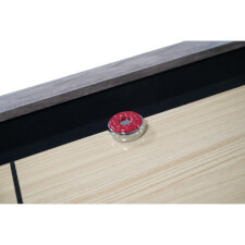 A puck on the shuffleboard play surface