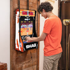Boy playing Arcade1up NBA Jam Partycade.