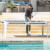 People playing Cornilleau Hyphen Outdoor pool table.