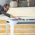 People playing Cornilleau Hyphen Outdoor pool table.