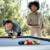 People playing Cornilleau Hyphen Outdoor pool table.