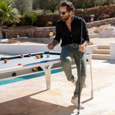 People playing Cornilleau Hyphen Outdoor pool table.