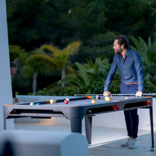 People playing Cornilleau Hyphen Outdoor pool table.