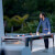 People playing Cornilleau Hyphen Outdoor pool table.