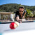 People playing Cornilleau Hyphen Outdoor pool table.