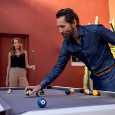 People playing Cornilleau Hyphen Outdoor pool table.