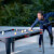 People playing Cornilleau Hyphen Outdoor pool table.