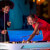 People playing Cornilleau Hyphen Outdoor pool table.