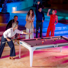 People playing Cornilleau Hyphen Outdoor pool table.