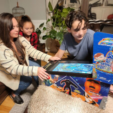 Family playing on the Pinball Micro.