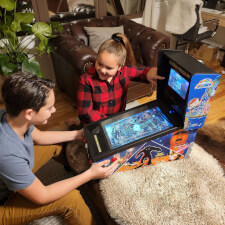 Family playing on the Pinball Micro.
