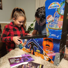 Family playing on the Pinball Micro.