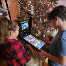 Family playing on the Pinball Micro.