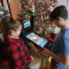 Family playing on the Pinball Micro.