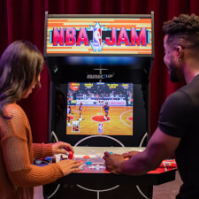 People playing Arcade1Up NBA Jam machine.