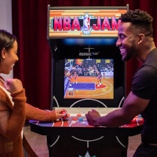 People playing Arcade1Up NBA Jam machine.