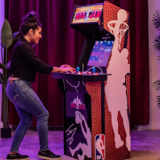 People playing Arcade1Up NBA Jam machine.