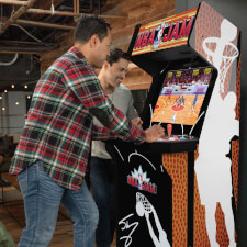 People playing Arcade1Up NBA Jam machine.