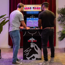 People playing Arcade1Up NBA Jam machine.