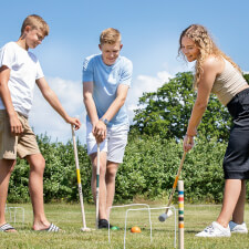 People playing Croquet Family set.