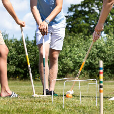 People playing Croquet Family set.