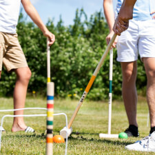 People playing Croquet Family set.