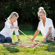 People playing Giant Mikado family game.