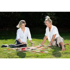 People playing Giant Mikado family game.