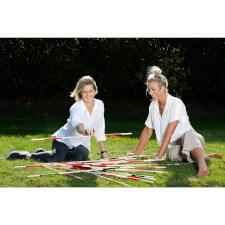 People playing Giant Mikado family game.