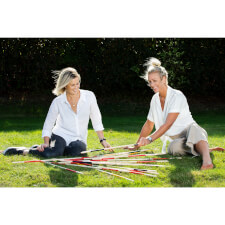 People playing Giant Mikado family game.