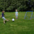 Kids playing Football Ball Rebounder.