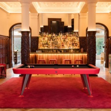 Diagonal Indoor Pool Table in Red with Black Cloth.