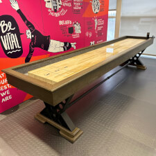 The Vienna 12ft Shuffleboard Table installed in a room.