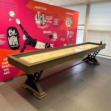 The Vienna 12ft Shuffleboard Table installed in a room.