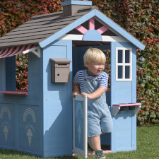 A Kid playing in the Icecream playhouse.